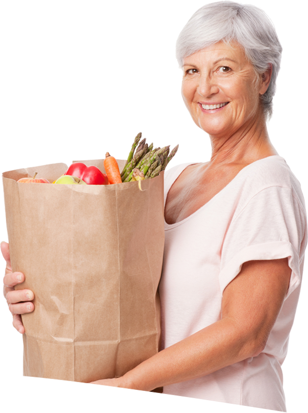 Smiling woman holding a bag of groceries.